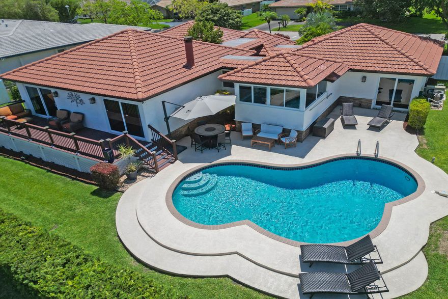 Discover this stunning Coral Springs home that's ready to impress! Topped with a brand-new roof from November 2021 and free from HOA fees, this property offers peace of mind. Step inside to find full impact glass throughout, paired with a striking entrance featuring dual atriums that frame the staircase leading to a spacious, open living area. There are four bedrooms. The primary suite steals the show with its stylish remodel, a large closet, and sliders opening to a gorgeous pool view. Both bathrooms have been beautifully updated, while the kitchen shines with all-new appliances. Outside, enjoy a refreshed pool complete with a new heater and salt system, perfect for year-round relaxation. A true gem worth checking out!