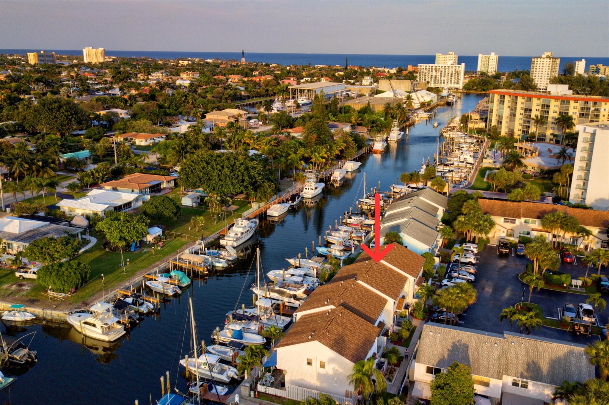 Welcome to the community of Sun Harbor townhomes. Located just a short 10 minute walk to the beach, this DIRECT waterfront unit has complete hurricane Impact windows & doors and a full size in unit washer & dryer. Out back you'll find a patio with a retractable awning and a custom bar to enjoy the constant boating action and entertainment! Assigned parking just steps from your door with plenty of additional parking. Community pool. HOA provides quick approvals! The townhome does NOT come with a boat slip. At times, dock slips are available to rent up to a 38ft boat. Easy to see and show!