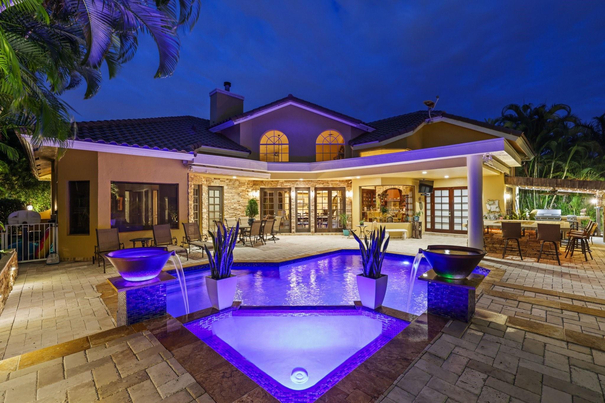 WITH NO STONE LEFT UNTURNED THIS BEAUTIFUL ESTATE HAS JUST HIT THE MARKET. Upon arrival you will notice a BRAND NEW ROOF FROM 2024 and a expanded travertine driveway that is paved all the way around the house and pool. As you walk through the entry way you will see SOARING 20ft ceilings that go all throughout the house accompanied by crown molding in every room. This home offers Hardwood floors and European tile in the kitchen where you will find Thermador appliances, Gas Range, 2 Dishwasher, 2 Sinks, 2 Drawer warmers, a Miele coffee/espresso machine, and pot filler. Built for entertaining, there are adjustable speakers in every rooms as well as in the backyard, where you can enjoy a heated/saltwater pool, shuffleboard court, 2 retractable awnings, and summer kitchen with an infrared grill