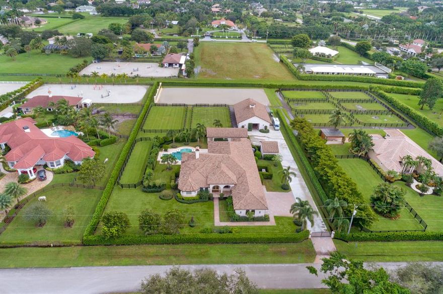 Beautiful 4Br/4.5Bth equestrian property w/ 1Br/1Bth guest house & 5 stall center-aisle stable. The home boasts an open floor plan w/ impact windows & doors and gourmet kitchen with center-island & granite countertops. The spacious master-suite with fireplace overlooks a stunning pool & private backyard. The outdoor entertaining space offers a full summer kitchen, gas fireplace & an aesthetically designed heated pool & spa with marble pool decking. Guests will enjoy the 1Br detached cottage w/ full kitchen & living room. The 5 stall barn w/ wash stall has been freshly remodeled & offers a generous tack room & lounge with kitchenette, 1/2bath & laundry facilities. The new arena is 185' x 80' w/ Martin Collins footing & mirrored wall. There are 3 generous paddocks & detached storage building