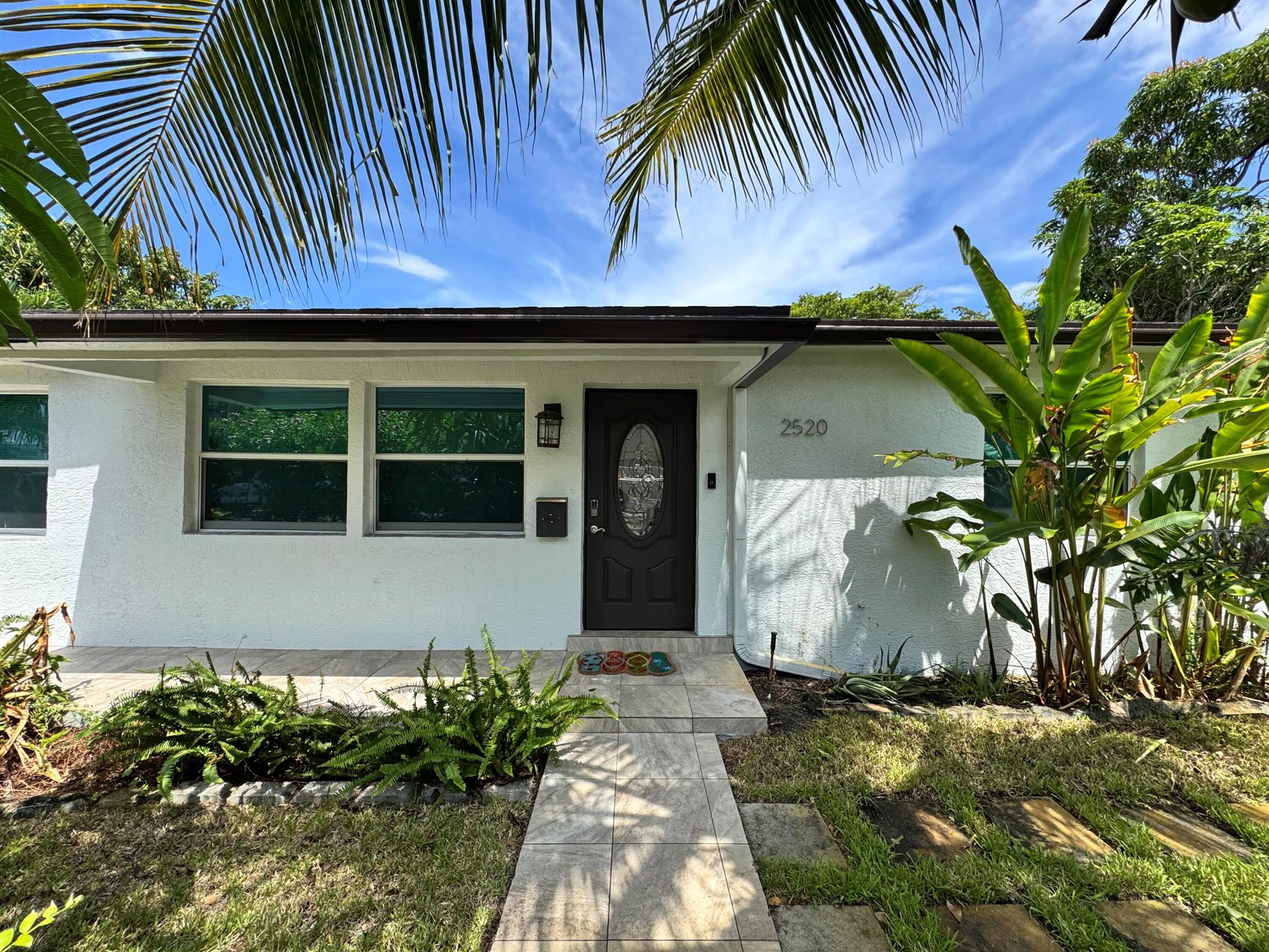 No HOA and an easy application process! Water, lawn care, electric and pest control included! Located just a mile from downtown West Palm Beach and PBI Airport, this beautifully updated home offers an excellent location near shops, restaurants, and activities. Situated on a private corner lot with a gated perimeter and carport. The home also features a private laundry room. Inside, enjoy a cozy family room with smart TV, dining area, and open kitchen. The spacious primary suite includes a luxurious bathroom. Two additional bedrooms and a second full bath complete the home. Close to CityPlace, beaches, Palm Beach Zoo, Drive Shack, Norton Museum, Clematis by night, and major highways are all within 5 minutes.