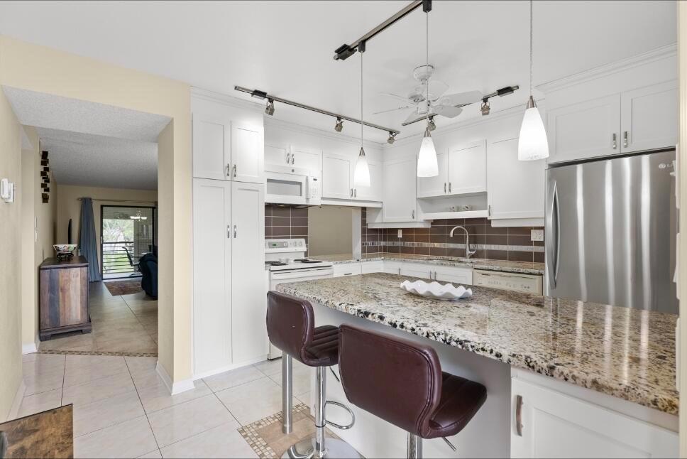 Welcome to your new home, desirable 55+ Lakes of Carriage Hills in Tamarac! This spacious 2BR/2BA condo is tastefully updated and move-in ready. Features include a modern kitchen with granite countertops, updated cabinetry, two renovated bathrooms with granite, and tile flooring throughout. Enjoy central air, ceiling fans, window blinds, and an exterior walk-in closet. Relax on your private patio, perfect for morning coffee or evening breezes. Community amenities include a pool, sauna, clubhouse with fitness center, tennis and pickleball courts, picnic areas, and walking paths. HOA covers all amenities for easy, low-maintenance living. Conveniently located near shopping, dining, golf, parks, medical centers, and just a short drive to Fort Lauderdale beaches. Credit Score required 600.