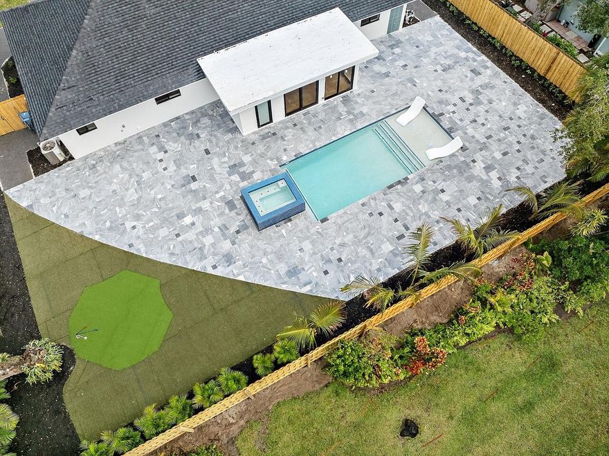 WALK TO THE BEACH! No expense spared in reinventing this exquisite true 3-bedroom home w/den. Major improvements completed in 2026 include new roof, impact glass doors/sliders, full electrical rewire w/new panel, new plumbing and sewer lines, spray foam insulation, new ductwork, and new A/C unit and handler. The stunning brand-new pool with raised spa features a sundeck, pool heater, and saltwater system, creating a private resort-style oasis.

The chef's kitchen showcases ALL-AMERICAN custom wood cabinetry, Taj Mahal quartzite countertops, full backsplash, and a grand waterfall island. Designer finishes abound throughout, including beach oak porcelain tile flooring, crown molding, upgraded baseboards, solid wood core doors, LED recessed lighting, and statement light fixtures and fans The baths have been tastefully redesigned with new tile, vanities, and glass-enclosed shower/tub combinations.

Additional highlights include an oversized laundry room with sink and upper and lower cabinetry, and a versatile denideal as a home office or gaming roomenclosed with a stylish barn door. The outdoor space impresses with a new fence, fresh landscaping, nearly 3,000 square feet of French-pattern marble decking, a putting green, and an outdoor shower.

Modern conveniences include EV charging, epoxy garage floor, impact garage door, Ring doorbell, smart appliances, and a custom living room wall with electric fireplace. The primary suite is a true retreat, featuring a massive 8x14 custom closet and a spa-inspired 6x6 shower with bench, niche, six jets, double-door entry, rain head, standard head, and handheld feature. Natural light pours in from the moment you step off the brand-new driveway through the custom front door into the open, entertainer-friendly main living area.