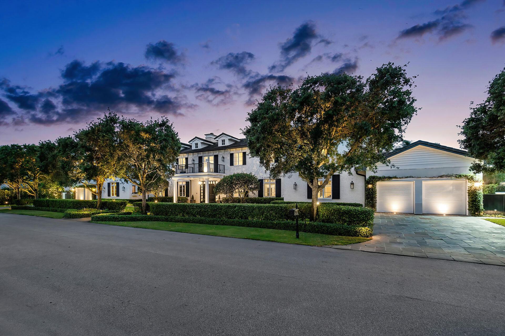2333 Acorn Palm Road is a stately residence that seems plucked from the idyllic charm of the Hamptons, a masterpiece conceived by Tuthill Architecture and brought to life by B&M Building Co. Situated on a prestigious double lot within the Royal Palm Yacht & Country Club this home epitomizes luxury living.As you step inside, the interior unfolds with a seamless fusion of traditional and contemporary elements, creating an exquisite designer's haven adorned with hardwood, marble floors, and bespoke millwork. The layout seamlessly integrates five bedrooms plus a library, all connected by first and second-floor galleries stretching across the residence's length. A sophisticated club room with a bar and billiards, a second-floor living room, and a practical mudroom add to the functional