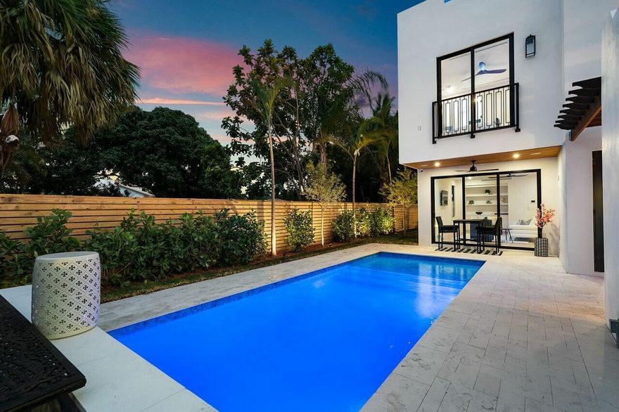 Discover unparalleled charm and sophistication in this brand-new Mission Revival home, ideally situated in the coveted College Park neighborhood of Lake Worth Beach. This architectural gem pays homage to the classic 1920s style while incorporating today's most sought-after modern amenities. From the moment you enter, you'll be greeted by soaring ceilings in the entryway that flood the space with natural light. The open-concept floor plan is anchored by a stunning chef's kitchen featuring top-of-the-line Thermador appliances, a quartz island, a pot filler, and a walk-in pantry with custom shelving. Perfect for entertaining or everyday living, the kitchen flows seamlessly into the great room and access the dining room via a butlers pantry.