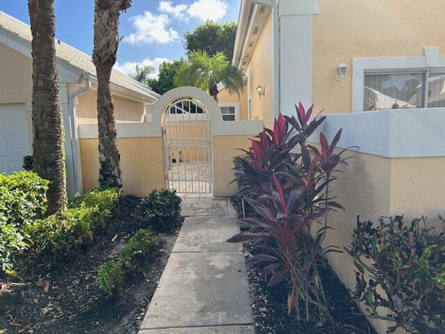 This perfectly kept oasis community in the heart of West Palm Beach is just what you've been waiting for! 24-hour manned security at both gates is a feature that everyone can appreciate. Whichever gate you choose to exit, it's a  straight drive east to  downtown West Palm Beach.  The Turnpike is minutes away and shopping options are too many to list.  Close to 441, Okeechobee Blvd, and the South Florida Fairgrounds! This home has beautifully installed wood floors, an enclosed patio that leads to a private back yard, and newly installed kitchen backsplash that perfectly blends with the granite countertops.