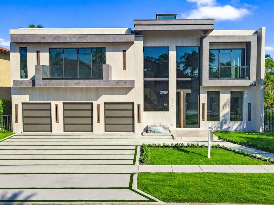 This newly constructed waterfront modern home by Soverns Developers combines luxury with a prime location and a newly constructed 80' seawall. Designed by the award-winning Barretta and Associates, the residence boasts architectural excellence with 5 bedrooms, 5 full bathrooms, and 2 half bathrooms. The main suite offers a private balcony, while the VIP suite ensures ultimate comfort. A tastefully appointed home office and a chef-inspired kitchen with Wolf and Sub-Zero appliances elevate the interior. A 3-stop custom glass elevator connects each floor, leading to a rooftop terrace with breathtaking views. Outside, enjoy a custom pool, spa, and a covered terrace with a built-in BBQ, ideal for outdoor entertaining. A 3-car garage adds convenience to this home of pure elegance.