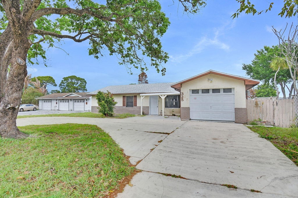Photo of 325 NW Rebecca Avenue, Port Saint Lucie, FL 34983 (MLS # B26075101)