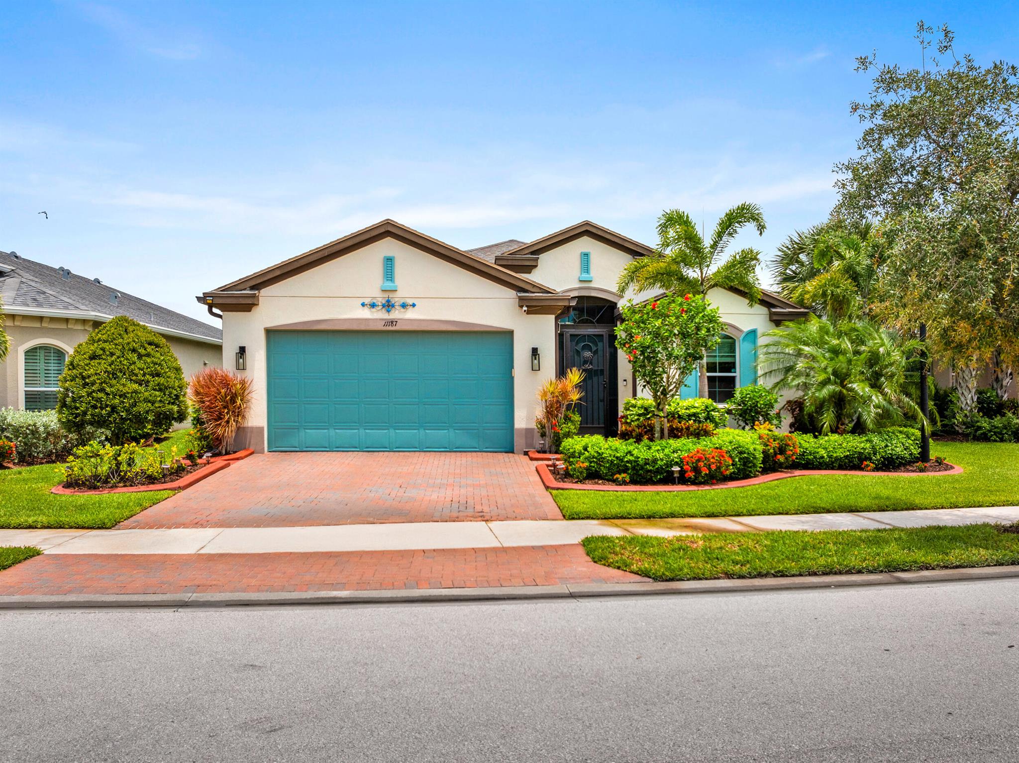 Skip the wait and skip the extra upgrades charges, this lakefront beauty has it all. Located in Lake Park at Tradition, this move-in-ready home sits on a premium lot and comes loaded with upgrades: hurricane impact windows, quartz countertops in the kitchen and all bathrooms, white cabinetry, wood-look tile, GE stainless appliances with double oven, and a screened entry. Enjoy a guest suite with private bath, designer backsplash, 8-ft doors, tray ceiling, master bay window, dual master sinks, large walk-in master shower, Triple sliders open to a covered lanai with custom landscaping and much more. Residents enjoy two resort-style clubhouses, pools, fitness centers, sports courts, and trails. Close to shopping, dining, and just 16 miles from the beach!