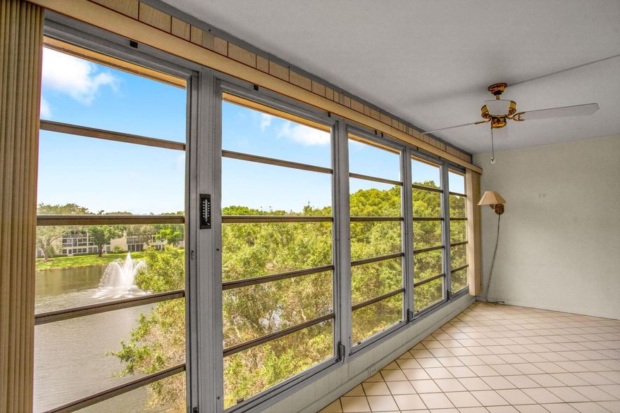Located on the top floor with a lake view, features a stylish jalousie glass enclosure and modern all-tile flooring, creating a sleek, carpet-free environment. This unfurnished gem allows you to customize your space and comes equipped with high-end stainless-steel mircowave and a French-style refrigerator,  white glass top stove. Enjoy hurricane impact doors and windows for added safety and a recently installed air conditioning unit from 2021 for year-round comfort. All assessments have been paid, adding tremendous value. Please note that at least one occupant must be 55 or older, and good credit and verified income are required by the association. Don’t miss out on this incredible chance to embrace a vibrant lifestyle by the water! See ALL PHOTOS, then see for yourself. Park #154