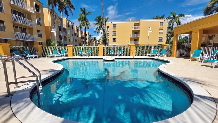 Welcome to this meticulously maintained 2-bedroom, 2-bathroom, first floor condo in the sought-after Sheridan East community. With ample natural light and an open layout, this unit is perfect for comfortable and spacious living. The Master suite includes a walk-in closet and private bathroom. Enjoy the convenience of the in-unit full sized washer and dryer. Relax on the private, lake-front patio facing a soothing fountain. Amazing amenities including a refreshing in-ground pool and jacuzzi as well as a clubhouse with a gym and secured bike storage. Directly across the street from convenient shopping; Publix, Starbucks, banking, restaurants and more! ONLY 1 MILE from the beach and quick access to major highways.