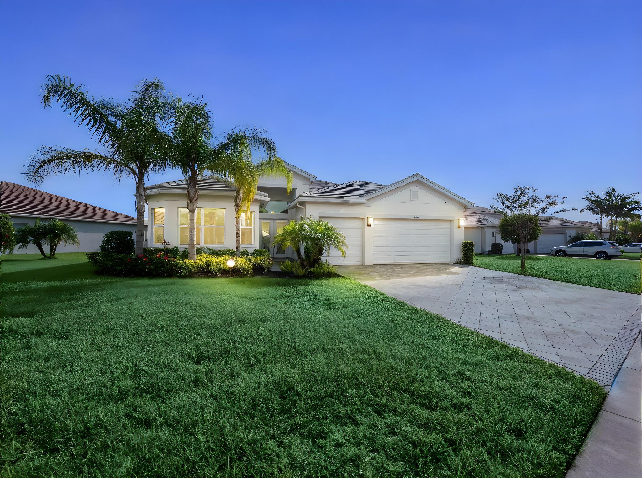 Located in the prestigious 55+ Valencia Cay community, this impeccably upgraded 3-bedroom, 3.5-bathroom plus den Julia model by GL Homes sits on one of the largest corner lots in the community--a premium 13,197 sq. ft. parcel compared to the standard 8,000 sq. ft.--offering a full, unobstructed lake view widely regarded as the best view in the neighborhood. With 2,753 sq. ft. under air and an extended 3-car garage, this home exudes elegance, functionality, and plenty of natural light. A flat concrete tile roof, impact windows and doors, and concrete block-stucco construction ensure both beauty and durability, while 14' volume ceilings, 8' interior doors, and tray ceilings throughout create an open and sophisticated atmosphere.