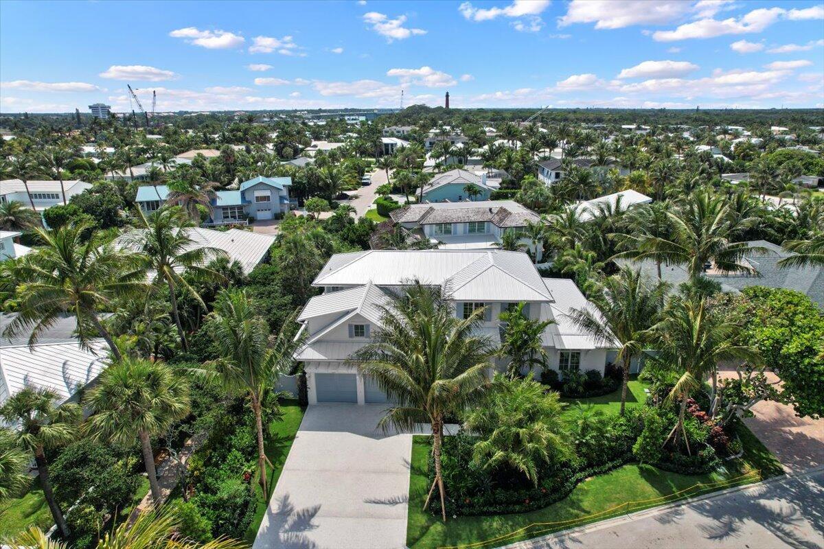 Experience the pinnacle of coastal luxury in this brand-new custom home, perfectly positioned in the exclusive Jupiter Inlet Colony on Jupiter Island. This prime interior location--just one home away from the ocean--offers effortless access to the beach via a scenic beach path. Designed for both sophistication and comfort, this masterpiece boasts an open-concept layout with meticulous attention to detail. The first-floor primary suite is a true sanctuary, complete with two walk-in closets and an elegant vanity station. The chef's kitchen is an entertainer's dream, outfitted with Downsview cabinetry, Sub-Zero & Wolf appliances, a walk-in pantry, and a built-in Miele coffee system. A separate bar area with a Sub-Zero wine refrigerator ensures seamless hosting. Luxury finishes throughout