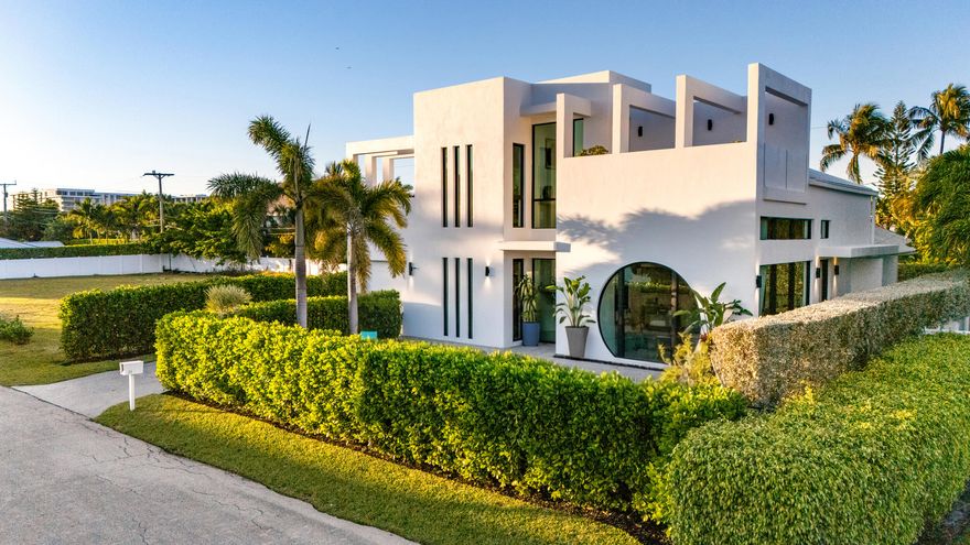 Located on a quiet seaside street in the heart Ocean Ridge just steps from the beach, this architecturally distinctive, newer-built smart home offers the best of refined coastal living. Spanning over 3,000 total square feet across two stories, the residence features four ensuite bedrooms, soaring ceilings, and a thoughtfully designed open layout. Walls of dramatic floor-to-ceiling glass provide for an abundance of natural light and showcase the home's ideal Southern exposure, creating seamless indoor and outdoor living. The chef's kitchen is a true statement, equipped with premium appliances from Gaggenau, Miele, and Wolf, combining sleek European design with professional-grade performance and tons of storage. Step outside to your own private retreat, complete with a sparkling saltwater pool, fully equipped summer kitchen, inviting alfresco dining area, generous green space, and a refreshing outdoor shower--ideal after a morning at the beach. Completed with a rooftop terrace where you can hear the ocean and feel the coastal breeze, this one-of-a-kind modern retreat delivers the ultimate in elevated seaside living. Call for more information or a private showing.