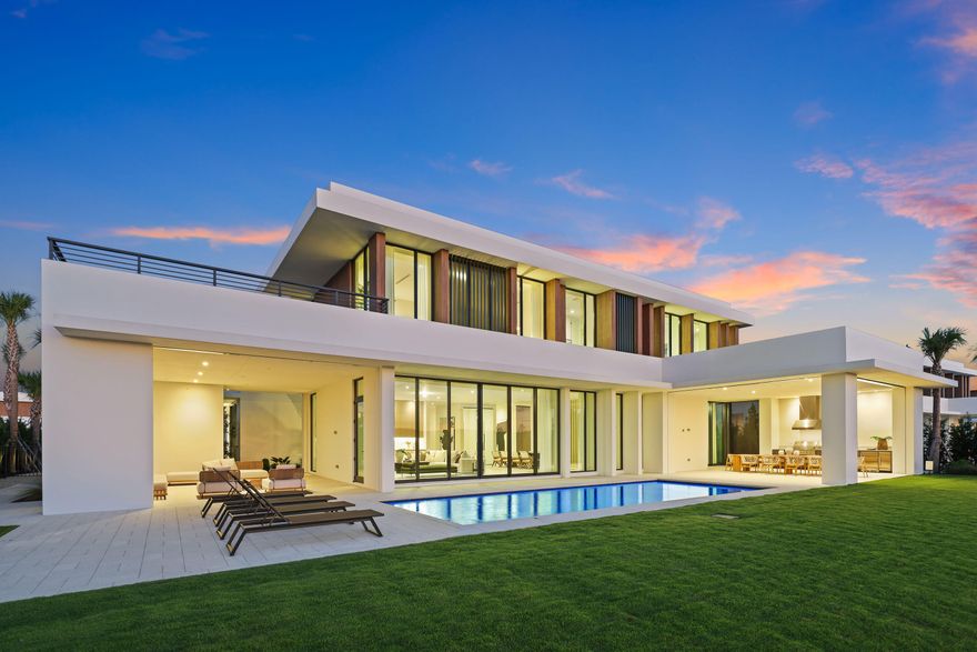 BRAND NEW, JUST COMPLETED—$400K Golf Membership Included!! This 5-bedroom, 6.5-bath estate by highly acclaimed architect Max Strang sits on a ½-acre lot in the most desirable location within Panther National, Palm Beach County's newest and most exclusive golf community. Enjoy the best views overlooking the lake, manicured greens, and spectacular sunsets. Spanning 11,023 total SF, the home offers 10'6'' ceilings, floor-to-ceiling glass, a 108-bottle wine cellar, and 2nd level loft area and wet bar. Full Smart Home automation includes Lutron lighting, solar panels, motorized screens, and automated shades. Outdoor living features multiple terraces, a summer kitchen, pool, and spa with golf and lake views. The chef's kitchen includes Wolf & Sub-Zero appliances, dual ovens, a spacious walk-in pantry, and catering kitchen. The primary suite offers dual spa-style bathrooms, dual oversized custom dressing rooms, a sitting area, and rooftop terrace. Additional features include en-suite guest rooms, an elevator, two laundry rooms, and a 4-car garage with EV charging. Residents enjoy a Nicklaus Signature Course designed by Jack Nicklaus & Justin Thomas, a state-of-the-art fitness center, resort-style pool, spa, and fine dining-luxury living in a private, modern enclave.