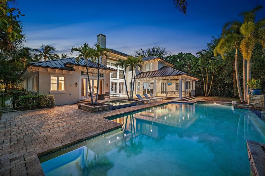 Experience the ultimate in luxury and privacy in this stunning estate masterfully crafted by Purucker & Marrano Custom Homes.  Only minutes to Palm Beach International Airport, beautiful beaches and 5-star dining, this home is perfectly situated on a prestigious cul-de-sac lot within the renowned gated golf community of Old Marsh Golf Club. Overlooking the 5th tee of the signature hole on the Pete Dye championship golf course, this residence offers breathtaking water and fairway views, a tranquil setting amid an Audubon-designated preserve. With no tee times required and a renowned caddie program, Old Marsh provides an exclusive and intimate golf experience unlike any other.  Meticulously designed, this 5-bedroom, 5.2 bathroom estate features an expansive floor plan, MORE...