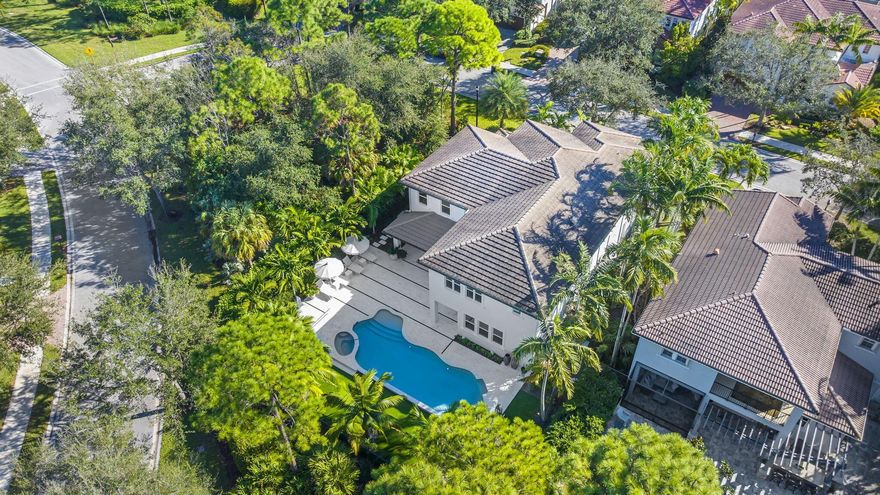 Presenting 905 Mill Creek Drive, a truly extraordinary residence nestled in one of Northern Palm Beach County's most coveted communities. Expertly reimagined and expanded by Palm Club Design Group, a renowned local design and construction firm, the residence sits on a highly sought-after corner estate lot just steps away from the resort-style clubhouse. This beautifully crafted home, situated in the heart of Evergrene, seamlessly blends luxury, comfort, and sophistication. Surrounded by lush, tropical landscaping, the property features expansive living spaces with impeccable attention to detail and craftsmanship at every turn.  Boasting 7 bedrooms and 6 bathrooms, this impressive home showcases the Elliston floor plan - Evergrene's largest and most desirable design.