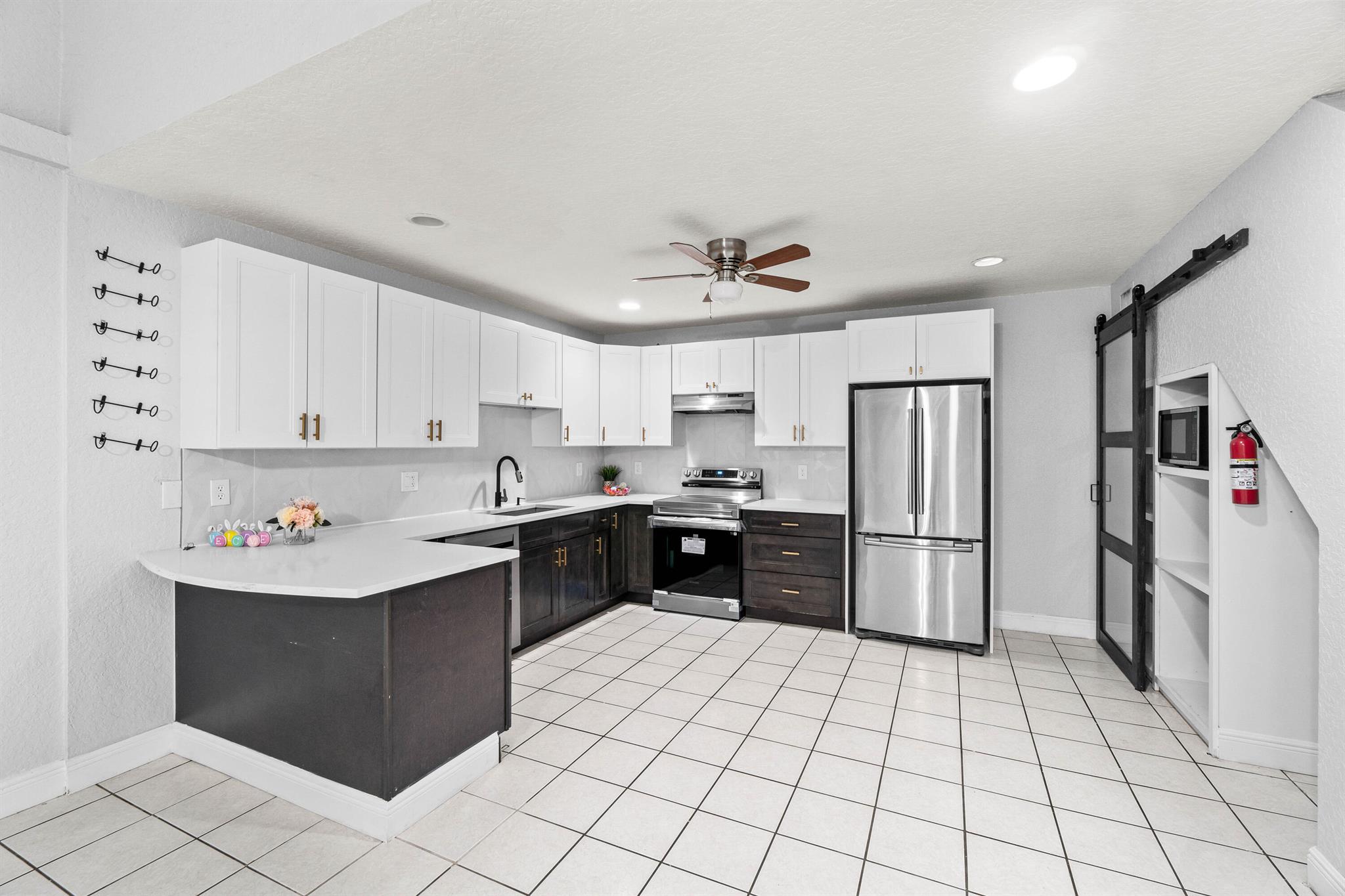 RARELY AVAILABLE TRUE 4 BEDROOM VILLA IN WELLINGTON. This beautiful 4/2 PLUS private loft, which can be used as 5th bedroom has recently been fully renovated. Brand new metal roof just installed. All 4 bedrooms are on 1st level. With over 2,000 sq ft of living space, it features an open concept living area and an enclosed sunroom. Beautiful fully renovated eat-in kitchen with real wood cabinets, new stainless steel appliances and new quartz countertop. Kitchen has lots of cabinets. Large master suite and renovated bathrooms. LG Washer and Dryer included. Completely fenced great for pets and kids. Outdoor and indoor patio area. Unit comes with 2 parking spaces. Tenant is responsible for all utilities. Tons of storage space throughout. Housing vouchers accepted.