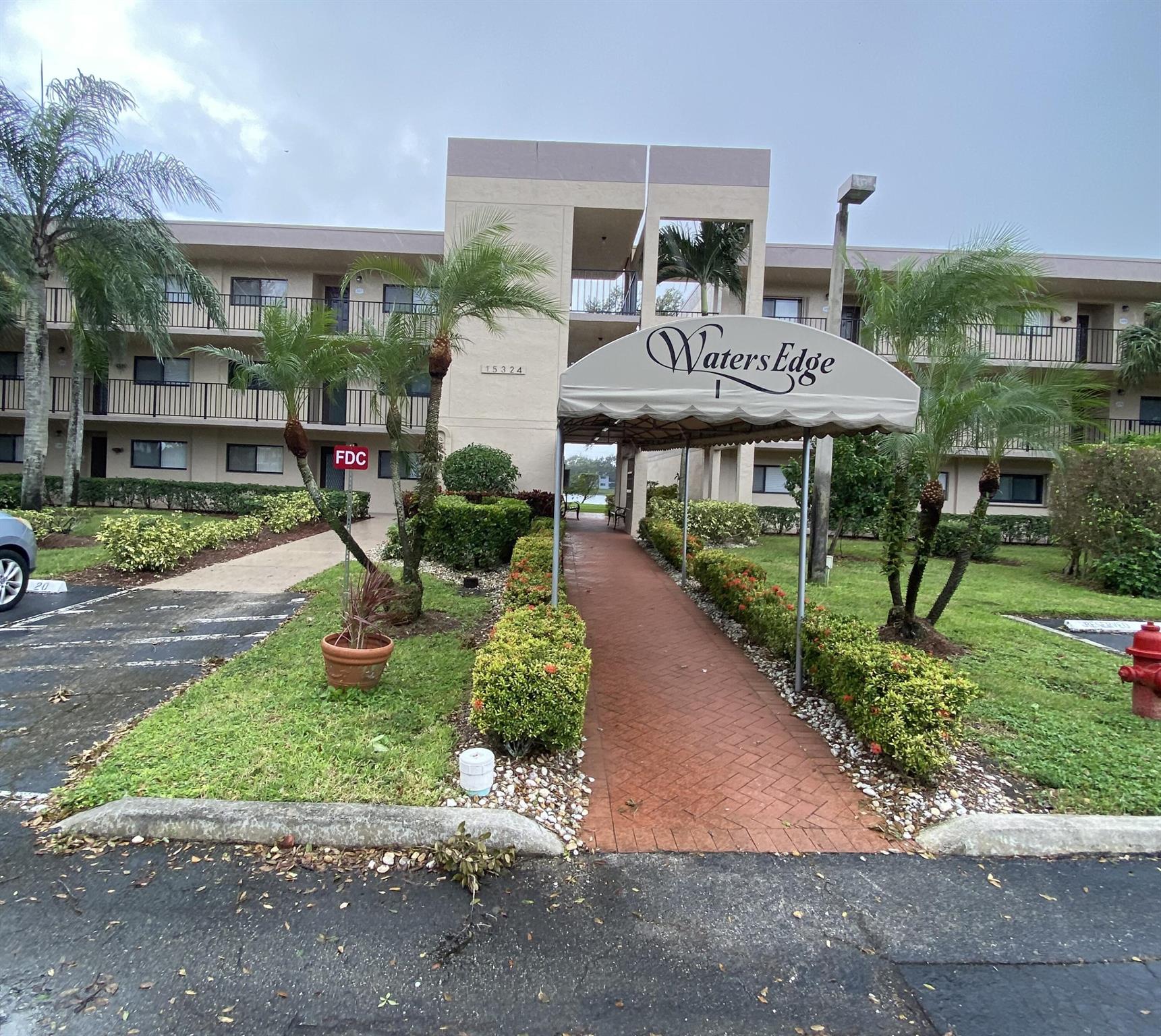 Motivated seller! THIS BUILDING HAS PASSED ITS MITIGATION INSPECTION! FULLY FUNDED 2025 RESERVES. NO SCHEDULED ASSESSMENTS FOR 2025 FOR WATERSEDGE I. SELLER WILL PAY CLUBHOUSE ASSESSMENT. Beautifully updated first floor condo with a gorgeous lake view in popular Lakes of Delray. Large patio accessible from living room and primary bedroom opens to the outside. The lovely eat-in kitchen features new wood cabinetry, quartz countertops, marble backsplash and new ss/appliances and has been opened to better flow into the living room/dining area. Both bathrooms are fully updated. New laminate wood flooring and interior paint. Newer water heater and washer/dryer. No popcorn ceilings. Accordion hurricane shutters. Assigned parking. All measurements approximate. Owner-agent.