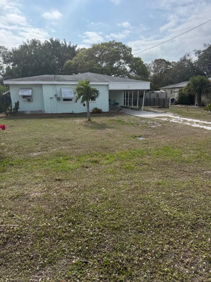 Perfect fix-er-upper home Centrally located on a quite paved road east of US Hwy 1 next to the Indian Hills golf course and a large lake with paved sidewalks close to shopping, beaches and the historic downtown Fort Pierce district. Solid concrete block construction 2008 roof & 2024 plumbing permit. 10,790 square foot lot w/backyard shed. Gross square footage under roof is 1675 Separate laundry/storage room off the carport. This is an estate liquidation Sellers are motivated to make a deal. The utilities are turned off & property Will not qualify for traditional financing in current condition