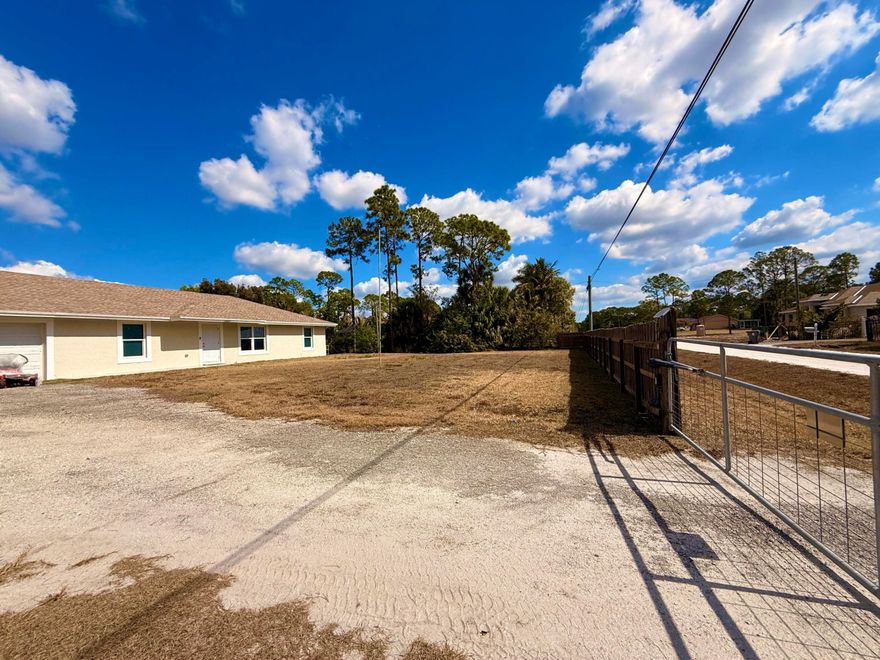 NO HOA !! 5 BEDROOM 2 BATHROOM ON 1.2 ACRES *** FULLY FENCED !!  WALKING DISTANCE TO WALGREENS , PUBLIX, MCDONALDS, BANKS, LIBRARY.   IMPACT WINDOWS AND DOOR **. KITCHEN WITH GRANITE, STAINLESS APPLIANCES, BREAKFAST BAR ***. COVERED BACK PATIO