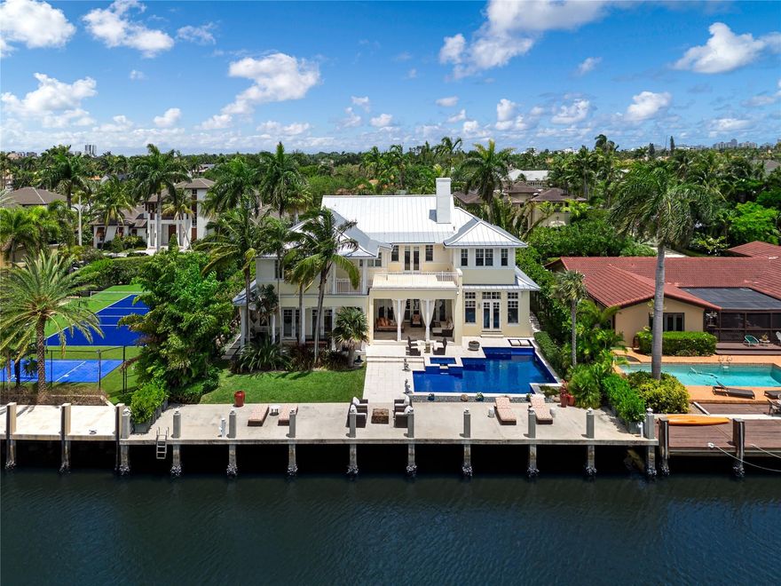 Nestled in the tranquil neighborhood of Rio Vista minutes from The inlet, The Yacht Club, Las Olas and the airport. This exquisite British West Indies-style residence stands as a testament to luxurious coastal living. Boasting 5 bed 5.5 baths, and a Clubroom encompassing 6,186 sq/ft of meticulously designed space. With 90 ft of waterfront along a wide canal, this residence provides breathtaking views for waterfront living. Updated kitchen showcasing Viking appliances. Whether preparing intimate or hosting this culinary haven is sure to inspire. Spacious wet bar & covered outdoor area, with a summer kitchen and cabana bath. The primary suite, featuring his and hers closets, a spa-like bathroom. Every detail has been meticulously crafted to create a space of ultimate comfort and elegance.