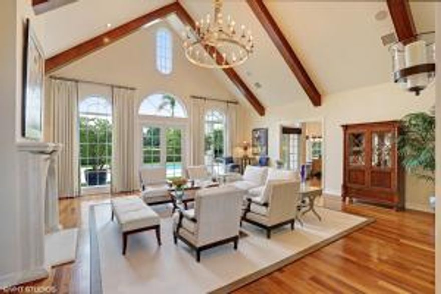 A magnificent home in the exclusive Royal Palm Yacht  & Country Club. This pristine home is ready for you to move in and can be purchased furnished. You will love the golf course view, the open floor plan, the colors and condition of this executive home:  A unique, nearly 4000sft single story with 3 large bedrooms, front office, media room and a very desirable 4 car garage ! The spacious interior is surrounded by a gorgeous exterior - landscaped for privacy on the 7th hole and perfect for entertaining. As you drive up, you will see the inviting landscaping and perfectly balanced allure inviting you in to this gracious home. The high ceilings enhance the foyer as you enter and the Brazilian wood floors and custom moldings shine throughout. The formal living room has a stone fireplace and...