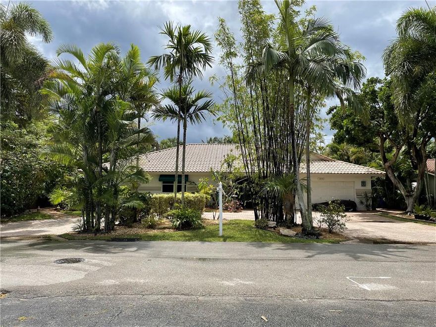 When you walk though the front door of this home you enter your own private oasis.  This paradise located less than a block from the intracoastal is on an oversized lot with a pool and lush tropical landscaping, winding paths with canal water views.  This home is perfect for intimate or large party entertaining with a large entry foyer opening into an open concept living, dining, kitchen area.  It has 3 large bedrooms , 2 large baths and a powder bath, a separate laundry room which also doubles as a butlers pantry.  All rooms in the back of the home have double French doors exiting onto the patio.  The backyard has covered patios, a tiki hut,  separate dining areas, multiple outdoor beds and outdoor storage.  The garage was converted to use as add’l  living space but can be converted back.