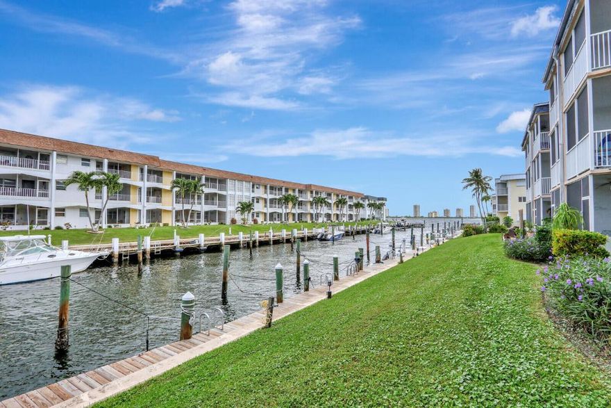 Age 55+, this is only for you! Winter in paradise! Beautifully renovated, ground floor, 1br 1 ba, located in a sought after 55+ waterfront community. This condo feels light & airy, with a kitchen that was redesigned to create an open floorplan. Updates include kitchen cabinetry, granite countertops, stainless steel appliances, breakfast bar, tile flooring, bathroom vanity, toilet, ceiling fans & lighting. Spacious bedroom with private screened patio overlooking the canal & boats. Accordion hurricane shutters for peace of mind during storms. Impact glass front door with built-in blinds. A/C is October 2021, Water heater is October 2016. Premium location in the building, with a covered entry that keeps the front door out of the elements and provides privacy from the parking lot.  >> Prime parking space right in front of the unit. Immaculate laundry room is directly across from the condo, 2 steps away. Storage closet for all your extras like luggage, holiday décor, etc. Monthly condo fee includes water & sewer, basic cable and building insurance. New owner can be put on the waitlist to rent a boat slip. Enjoy relaxed Florida living at the waterfront pool & clubhouse with friendly, fun, active neighbors. Perfect for fulltime or snowbird. This is a no pet community, however a service animal or pet with an ESA letter is welcome. Affordable living, centrally located near everything! Close to hundreds of stores & restaurants. Quick walk to Walgreens and several popular dining spots. Gorgeous Singer Island beaches are only 3 miles away. 20-minutes to Palm Beach International Airport makes traveling a breeze. Welcome home!