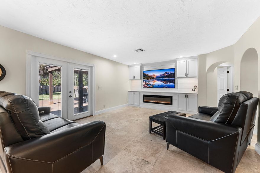 Rare nearly half-acre property with no HOA, upgraded living, and massive gated concrete parking for RVs, boats, trailers, or business equipment. SELLER OFFERING UP TO 3% TOWARD BUYER RATE BUYDOWN. This 4-bedroom, 2-bath home features soaring vaulted ceilings, marble flooring, new quartz countertops, and a custom built-in media wall with electric fireplace. Open layout, French doors, spacious primary suite, dual-head walk-in shower, and exceptional flexibility make this a rare opportunity for both lifestyle and utility.