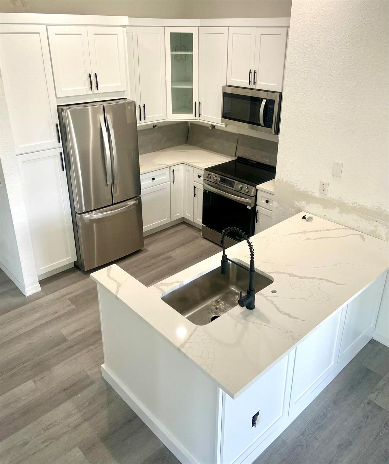 RENOVATIONS JUST COMPLETED for this 3 BEDROOM - 2 BATHROOM - 1 CAR GARAGE - LAKE VIEW condo in gated Palm Beach Gardens community. NEW KITCHEN, APPLIANCES, BATHROOMS, VINYL PLANK FLOORING, PAINT AND MORE......Arguably the best location in the community -- overlooks lake and fountain, steps to pool, guest parking, and close to entry gate. Open floor plan. Very light and bright with so many windows. Volume ceiling. Master BR has huge walk-in closet. Split bedroom plan. Balcony with wonderful lake and fountain view. Corner unit with private entrance. Attached garage. So convenient to shopping and restaurants. Private footpath from community to the new shopping center in Alton. Condo association requires minimum 700 credit score. HOW GREAT WILL IT FEEL TO LIVE IN THIS UPDATED CONDO?