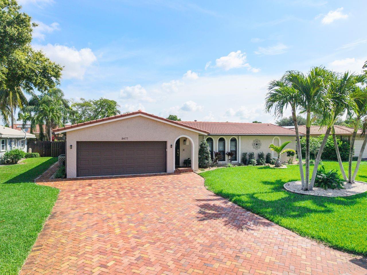 Wonderful opportunity in Coral Springs! 4 bedroom 2 bath Pool home on a HUGE 10,061 sq ft lot!! **Impact Windows and Doors installed in 2023!!**Remodeled Granite Counter Top Kitchen With Stainless Steel Appliances!! Remodeled Bathrooms!** New 2024 A/C Unit!!** New flooring and paint The manicured, LARGE FENCED IN BACKYARD and POOL is perfect for entertaining and Florida living! The 2 car garage with an oversized driveway that can accommodate 4 additional cars ! This sought after community has NO HOA!! Close to shopping, restaurants and parks in the heart of Coral Springs!