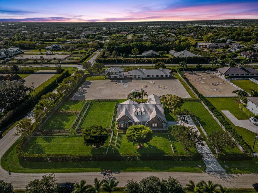 Exceptional Equestrian Estate in Saddle Trail Park, this 2.45-acre, high-and-dry farm is a premier offering. Conveniently located on city water and less than 2,500 feet from WEF's entrance, this property is designed for the serious equestrian.  The farm features 7 irrigated paddocks and a Wordley Martin constructed arena measuring 220'x130'. The barn is accessed through an electric-operated gate with a roadside apron, providing easy entry for tractor-trailers and ample space behind the barn for large truck and trailer parking.  The state-of-the-art barn boasts:  12 stalls, each equipped w/ high powered fans.  Room for temporary stalls in the auxiliary building.  Four grooming stalls (three indoor, one outdoor).  Three wash racks with hot and cold water.