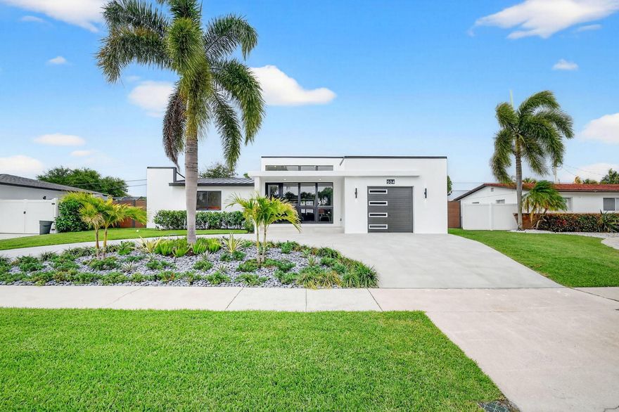 Welcome to 504 Flotilla, a beautifully renovated home offering 2,210 square feet under air (2,640 total), thoughtfully rebuilt with all major upgrades throughout.   The interior features a modern kitchen with quartz waterfall countertop, high end appliances, gas range, pantry, and wine cooler. Refinished terrazzo floors and large tile run throughout, complemented by high-end bathrooms, electric blackout shades, and custom walk-in closets. Expansive impact windows and doors fill the home with natural light. Step outside to your private backyard retreat featuring a newly built heated pool (2025), turf, fresh landscaping, new fencing, and a spacious deck with a sleek custom outdoor kitchen—ideal for relaxing or entertaining.   Additional upgrades include a new metal roof, new AC units, squared gutters, tongue-and-groove cedar soffits, a new sprinkler system, and professionally designed landscape lighting. The driveway is finished in porcelain tile for a clean, modern look.  The home also features a new plumbing system, new underground electrical service and wiring, and gas lines servicing two tankless water heaters, the dryer, range, and outdoor grill.  Located in North Palm Beach, a golf cart-friendly and family-oriented community, residents enjoy parks, playgrounds, volleyball courts, a public boat launch, and regular neighborhood events. The home is also just minutes from the North Palm Beach Country Club, offering golf, tennis, restaurants and oversized heated pool and splash pad. MUST SEE!