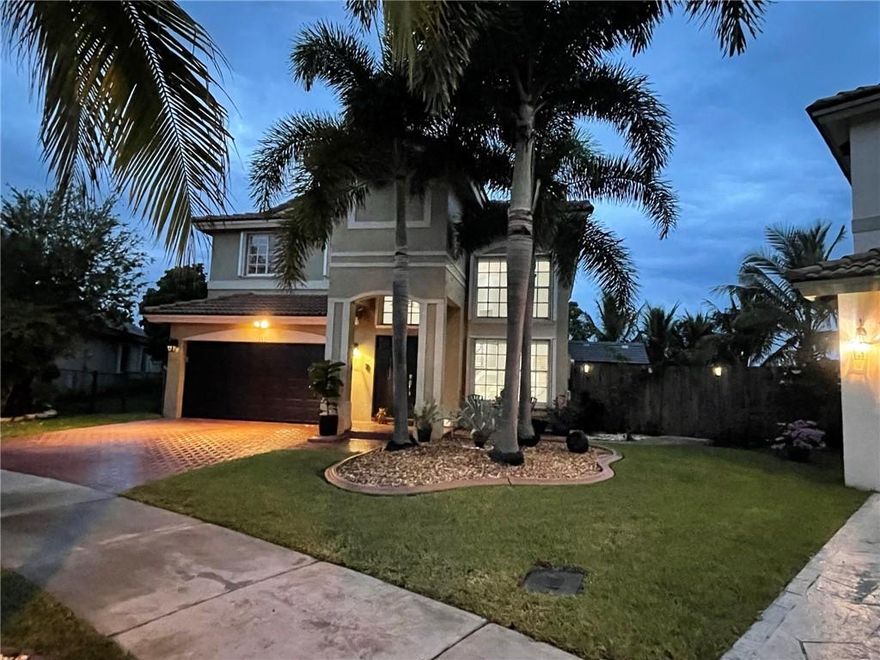 Paradise Found! Beautifully appointed 2 story, full 4 bed, 3 full bath (1 bed, 1 bath on first level) with oversized 2 car garage on cul-de-sac. Completely remodeled. Stainless appliances included. Carrera marble & wood floors, crown molding, chair rails, LED lighting throughout, A/C with purifier system, accordion shutters, over sized lake front lot with fruit trees, gazebo and beautiful palm trees.  Beautiful sunset views off the lake and plenty of room for a pool.  Pavers on driveway and side walk around house.