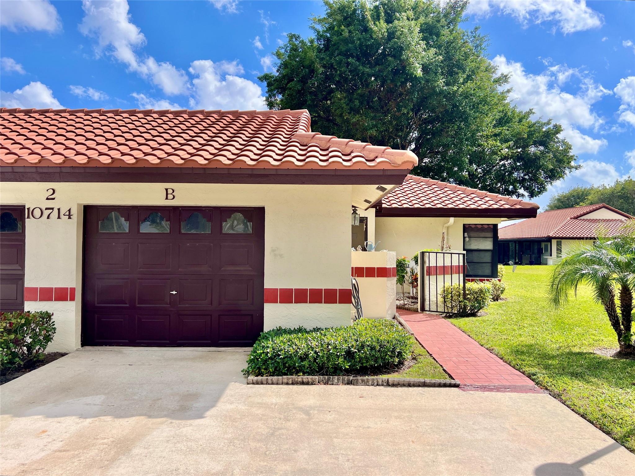 Bright 2-Bedroom, 2-Bathroom Villa with 1-Car Garage. Conveniently Located directly across from the Clubhouse. Open Concept Living/Dining Space with additional Den/Office. Vaulted Ceilings with 3 Skylights. Spacious Enclosed Lanai adds 300 SF of Entra Space and Private Backyard. Large Master Bedroom with Walk-in Closet. Laundry room inside Unit. Condo Fee includes Reserves, Insurance, Building Exterior/Roof, Water/Trash, Cable/Fiber Optic Internet, Pest Control and Clubhouse with Incredible Amenities! Desirable Gated Community Set Back 1/4 mile from Military Trail with Beautiful Lakes & Trees. Clubhouse Includes Olympic Sized Temperature Controlled Pool (Heated/Cooled) and Hot Tub. Fitness Rooms, Card Rooms, Ping Pong, Billiards, Pickleball & More! Active 55+ Community. ESA Pets Welcome!