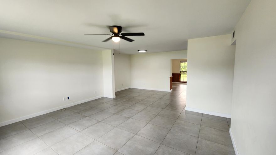 Recently refreshed and move-in ready, this Port St. Lucie gem offers rare space and major updates on a fully fenced 1/2-acre lot—double the size of many standard homesites. Enjoy peace of mind with a new roof (2025) and new A/C (2022). Inside, you'll find bright living areas, updated finishes, and a functional layout designed for everyday comfort. The kitchen offers ample cabinetry and flows into the main living space, ideal for entertaining. Bedrooms provide flexibility for guests, family, or home office needs. Outside, the oversized yard offers endless possibilities—add a pool, park your boat or RV, build a workshop, garden, or simply enjoy room to roam. Conveniently located near shopping, dining, parks, schools, and major roadways, this property combines comfort, value, and the Florida