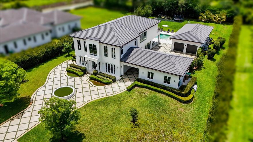 This custom built exquisite estate was designed with elegant architectural details and sleek modern finishes.  This gated estate sits on a beautiful acre plus lot with lush landscaping and a relaxing pool with patio area.  This estate has beautiful natural lighting.  The two story main house features 6 spacious bedrooms, 4 bathrooms, recreational room, theatre room, and glass wine room. The 6th bedroom is being used as an office. The gourmet kitchen includes Miele double ovens, Miele built in coffee maker, custom cabinetry, vast counter space and island. The guest house features a spacious living room, full size kitchen, 1 bedroom, 1 bathroom and patio area.  The main house and guest house are both connected to two separate double car garages. This estate is truly remarkable in every way.