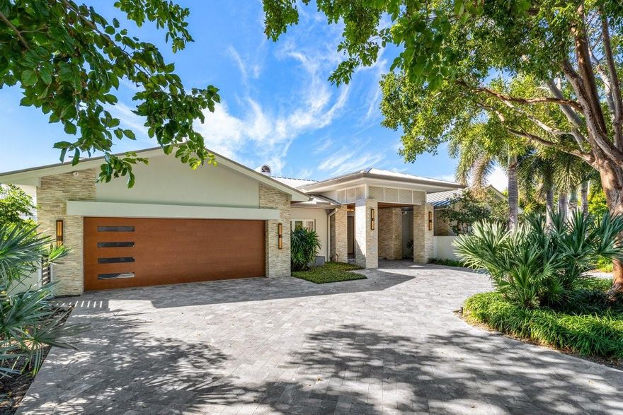 This exquisite residence graces an interior point lot within the guard-gated neighborhood of Bay Colony- arguably the most prestigious waterfront community in South Florida. This residence offers 212' of coveted waterfront w a 92-foot dock on one side + ample space on the other for additional boat parking. The home underwent a complete renovation in 2018 & further enhancements in 2024 including an expanded kitchen, custom bar & a meticulously redesigned primary bathroom, power shades, & a circular drive, all elevating the residence to new levels of unparalleled sophistication. Formal living spaces seamlessly blend w an open-concept kitchen & family room, all boasting waterfront views. Heated salt water pool & spa complete this idyllic waterfront haven w direct Intracoastal & ocean access.