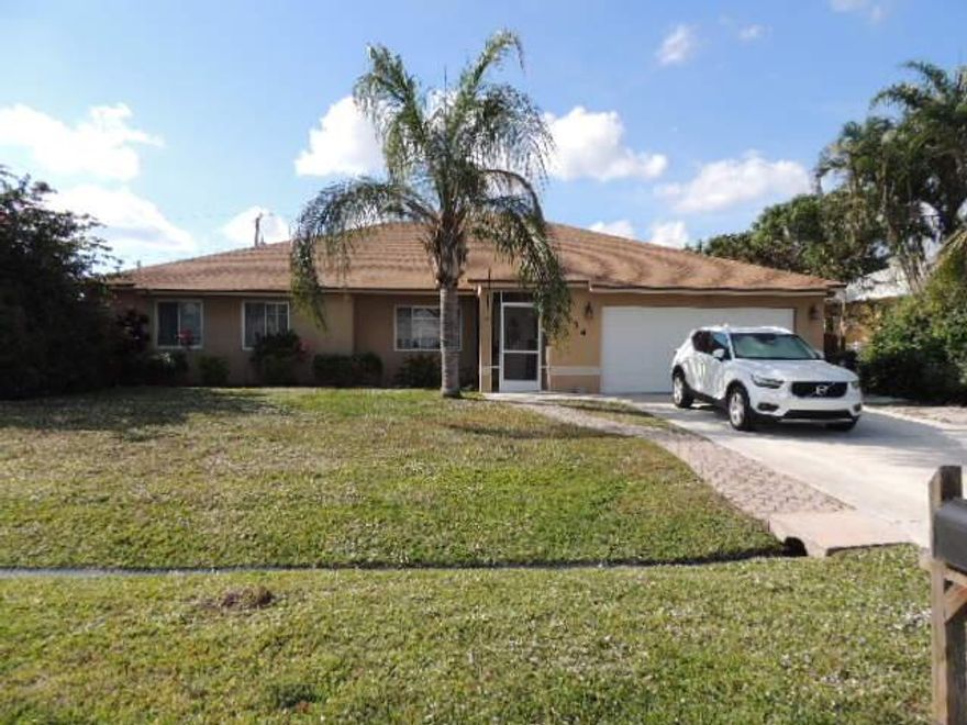 Look no further for your tropical oasis. Everyday can be a vacation in this beautiful 4 BR 3 Bath home. This home offers new roof (2024), A/C (2021), Water Heater (2025). Once you enter, you will step into a Great Room/w Kitchen open to the Dining Area and Living Room. Take notice of the stone floors and granite counter tops w/ huge Kitchen Island.  From here you can enter thru 2 sets of French Doors and will find a huge Entertainment Room where the party will start.  This area is outfitted with a bar and perfect for movie nights or those game day parties.