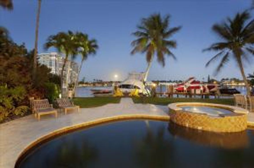 Irresistible tropical charm fills every corner of this lushly landscaped, one-of-a-kind historic compound directly on the Intracoastal Waterway.  Dating from 1928, this authentic Mizneresque gem has been stylishly renovated in relaxed island ease.  An airy veranda opens by the alluring pool with spill-over spa.  Lounge areas edge the 100+/- foot shoreline served by a 60+/- foot dock and a 12,000 pound lift.  This provides safe harbor for a sizeable yacht in a minimum-wake zone.  Anchored by a vine-covered pergola, a leafy courtyard connects to the private guest house containing a living room with fireplace, kitchen, bedroom and bath.  The estate also features a new Chicago brick drive, a 3-bay garage and full-house gas generator.