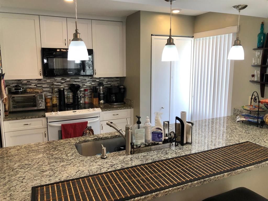 Photo of 405 Brackenwood Lane S #405, Palm Beach Gardens, FL 33418 (MLS # R10798247)