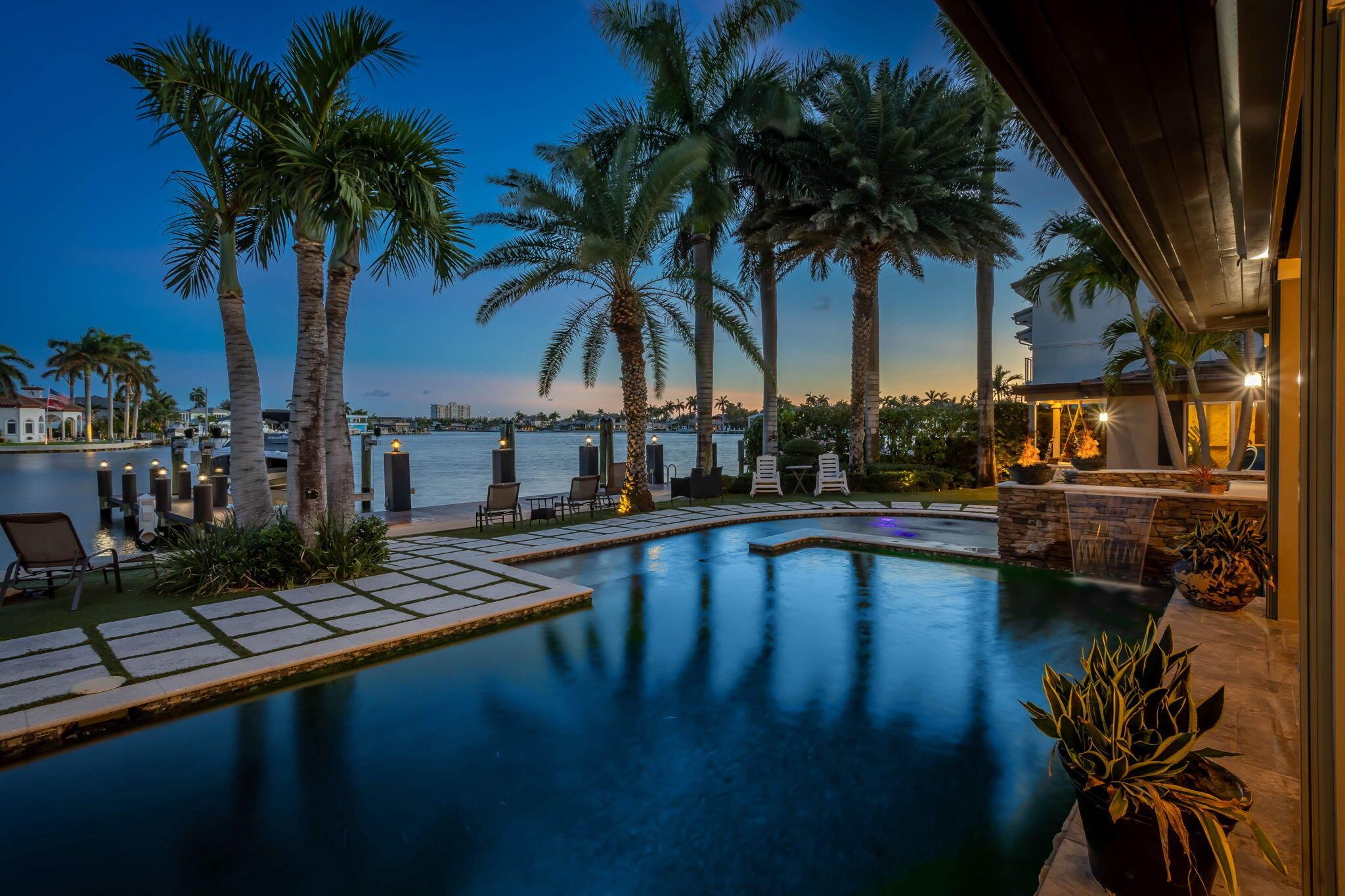 Welcome to a rare jewel of South Florida living--this architecturally stunning, custom-rebuilt waterfront estate blends timeless elegance with modern coastal sophistication. Reimagined in 2013 with an eye for detail and design, this one-of-a-kind residence offers the ultimate in luxury, comfort, and lifestyle. Tucked away on a wide deep-water canal with no fixed bridges, this home is a boater's dream, offering four dock slips, a 20,000 lb boat lift, 100 amp power, and a commercial-grade floating dock and ramp. Enjoy peace of mind with a new roof and full impact windows and doors throughout. Inside, you'll find beautifully remodeled living spaces filled with natural light, gracefully open interiors, and high-end finishes that transition seamlessly to the outdoors.Don't miss this oppertunity