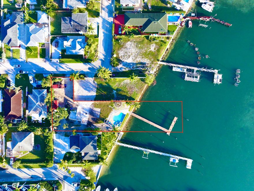 The outdoor grill with a large island makes hosting gatherings a breeze, while the dock space provides the perfect spot to park your boat. Don't miss out on this incredible opportunity to build your dream waterfront home with beach access! Start living your waterfront dream today!"