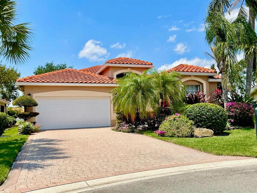 Water views from almost every window in this beautiful home.  This home is on a cul-de-sac, with one of the largest waterfront lots in this gated 55+ community.  The foyer has a handmade Moroccan leather chandelier.  It has tile throughout, volume ceilings, LED recessed high hats throughout, a spectacular kitchen with granite countertops, brand new appliances, and a huge island!  There are three bedrooms (one currently configured as an office), and two full baths, a two car garage and large driveway. There's a tiled and screened patio overlooking the beautiful lake to watch the sunset.  The HOA fee covers lawn, cable, internet, alarm system monitoring, exterior paint, beautiful clubhouse, and 24/7 manned gate.