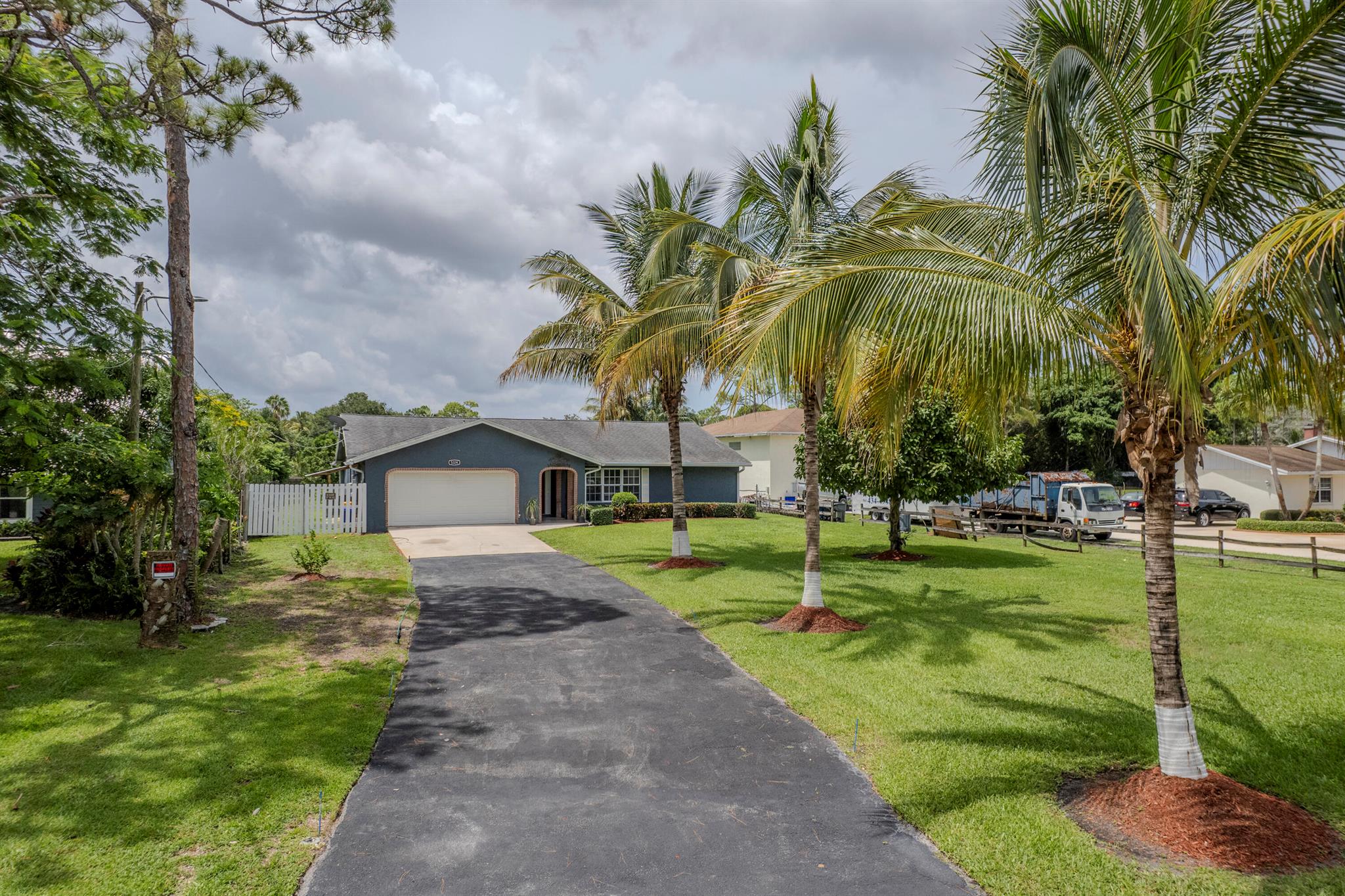 No HOA!! Remodeled Ranch Style Home sits on a 1/2 Acre with endless possibilities. Your own little tropical oasis with plenty of Fruit Trees and Palm Trees. Home features a split floor plan with 4 spacious bedrooms, all with walk in closets. Main Suite has sliding doors to Patio area, walk in closet and main bathroom has step shower. Enjoy the oversized covered enclosed patio area perfect for entertaining. Guest Bathroom is a cabana bath easily accessible from patio. One guest bedroom has private entrance from patio. perfect for guest or multi-gen living. Spacious home with Family Room, Dining Room with slider to the Patio, Kitchen is Open to Den and Breakfast Area. Kitchen has newer Appliances, Island, walk in pantry and plenty of counterspace and cabinets. Super clean home with