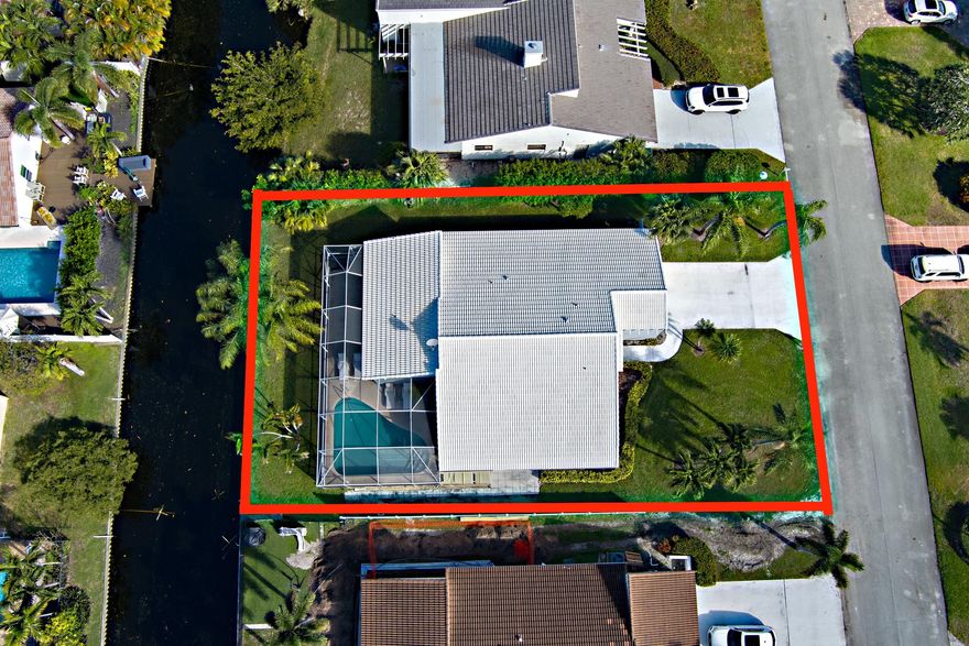 Don't miss this opportunity to live in desired Boca Lake Estates, one of the few manned gated communities in East Boca Raton, minutes to the Beach, located on a canal, $60k Seawall, $50,000 screen enclosure, fabulous kitchen, stainless steel appliances, ceramic flooring 36 x 36 throughout living area, soaring ceilings and open floor plan, newer A/C. Island in kitchen is virtual staging. Walk to Boca Paddle a massive $20 million, 100,000 sq/ft indoor/outdoor climate-controlled racquet sports complex set to open in early 2026 it will feature 19 pickleball  courts and 6 padel courts along with a full-service Farmer's Table restaurant, as well as saunas, cold plunge pools, a pro shop, a work lounge with private call booths, close to the Public Boca Country Club Golf Course, Costc
