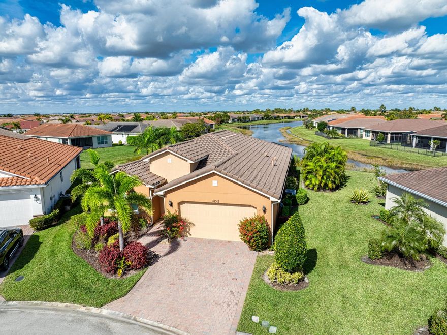 This exceptional 3-bedroom, 2-bath residence offers over 2,000 square feet of thoughtfully designed living space with breathtaking, long-lake views that stretch the entire length of the water. Perfectly situated on a quiet cul-de-sac, the home features a rare pie-shaped, oversized lot that enhances both privacy and outdoor enjoyment. An expansive covered, extended, and screened lanai creates the ideal setting to relax or entertain while taking in the serene lake views. Inside, the open-concept great room is designed for gatherings, seamlessly blending the living, dining, and kitchen areas—all overlooking the water. The kitchen is a true showpiece, complete with a large center island, upgraded 42-inch cabinetry, stainless steel appliances, and abundant storage. The spacious primary suite features a charming bay window, allowing natural light to pour in while framing tranquil views. Impact windows, a durable tile roof, and custom lighting and window treatments add both style and peace of mind. The second and third bedrooms are generously sizedperfect for guests or easily adaptable to a home office or flex space. A rare opportunity to own a lakefront home that combines luxury, functionality, and an unbeatable view.