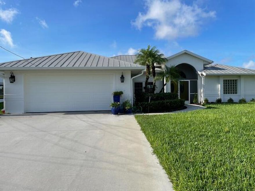 Great house on Canal 24. Can have a dock put up. All the storm windows and doors including garage door are included. Huge back yard that goes on forever - No neighbors in back, can see them across the Canal. Fruit trees - Banana! Sprinkler system comes from the water in canal. Invisible fence for your dogs. Fantastic neighborhood!   Rolldown storm screen in pool enclosure .Garage has tons of built ins fior storage, plus attic with pull downstairs. Home Warranty for a year on everything but the pool, everything in the house is covered!