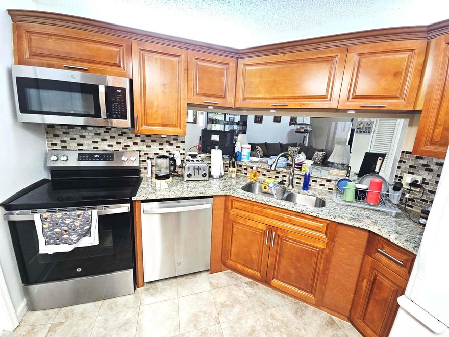 Gated and manicured community in the hart of Boynton Beach. Renovated 1st floor unit with a garage. Vaulted Ceilings, Granite counter and newer stainless appliances in kitchen. Quartz counters in the bathrooms. Tile floor all trough except the guest bedroom. Screened porch looking at a wide green space and the canal.  Walking stance to the pool and tennis courts.  No assessments.  Motivated Seller!